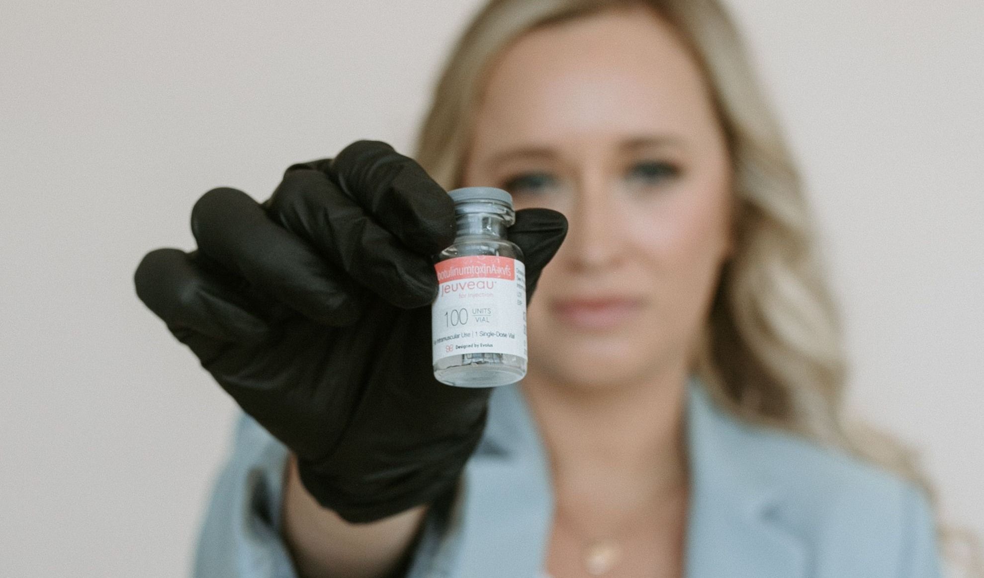 Crown Med Spa team member holding bottle of Jeuveau